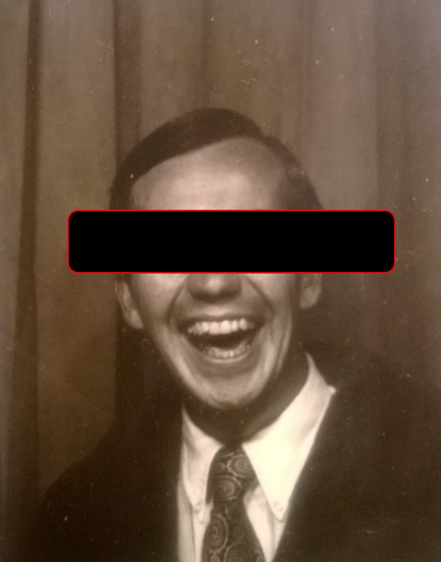 black and white photo of the author's Father.  He has a large-mouth smile.  