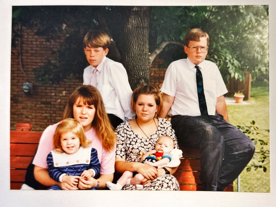 the six children all sit together for a family photo.  their faces are not happy looking.  the eyes are sad except Karen's.  she was always well taken care of