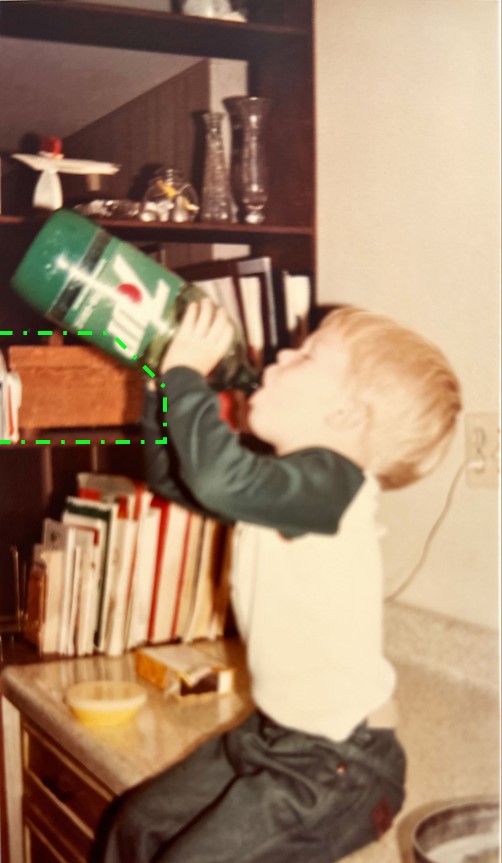 Kurdt sits on the kitchen counter in Copper, AZ, drinking 7up directly from the 2 liter bottle. about 1980.