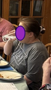 Karen drinking water from a glass.